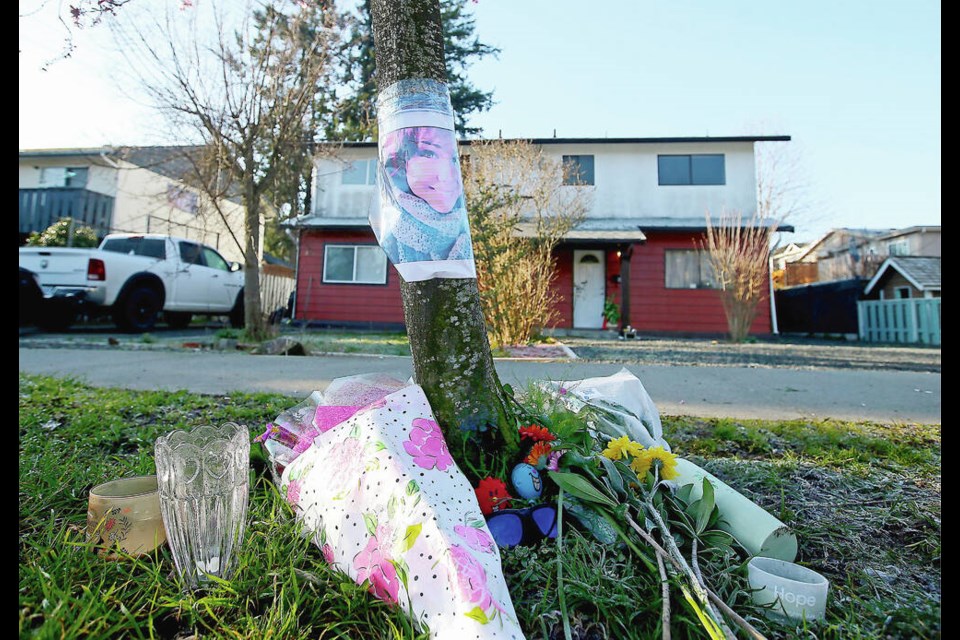 A memorial of flowers and a photo in front of the house on Arncote Avenue in Langford where Angela Dalman was killed on March 6, 2020. ADRIAN LAM, TIMES COLONIST 