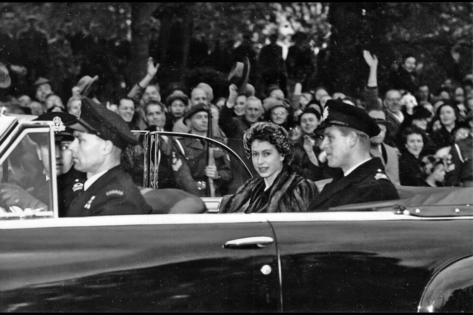 Princess (at the time) Elizabeth and Prince Philip appear to enjoy the part of their drive which took them through cheering lines of citizens on Rockland Avenue during their October 1951 royal tour. Times Colonist file photo