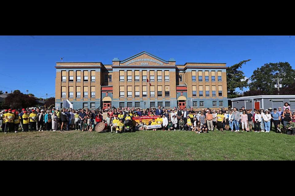 A group photo in front of George Jay school on Monday, echoing one from an earlier era. ADRIAN LAM, TIMES COLONIST 