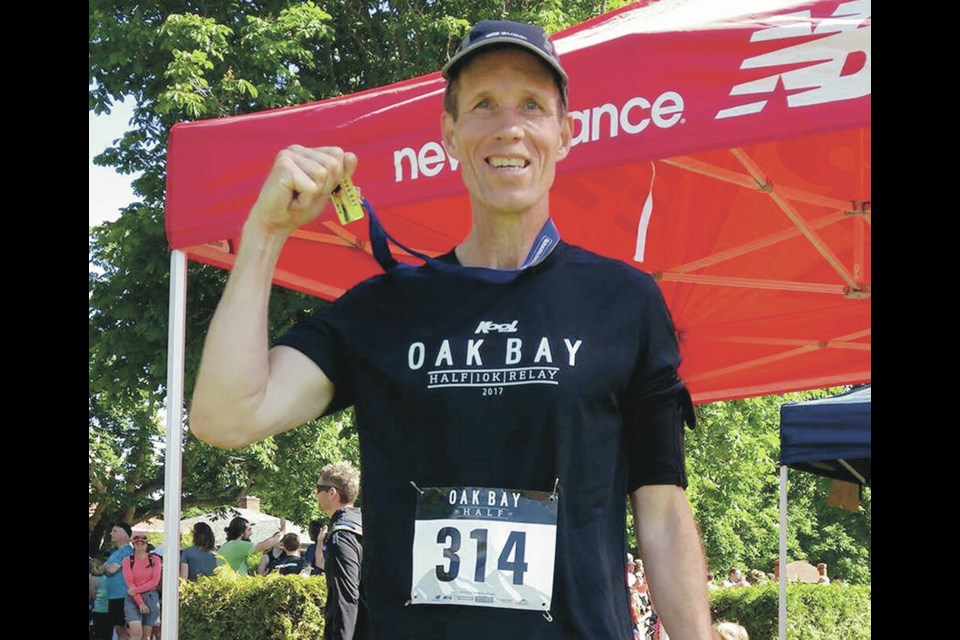 Tim Mackness after crossing the finish line at the Oak Bay half-marathon. COURTESY OF TIMOTHY MACKNESS JR.