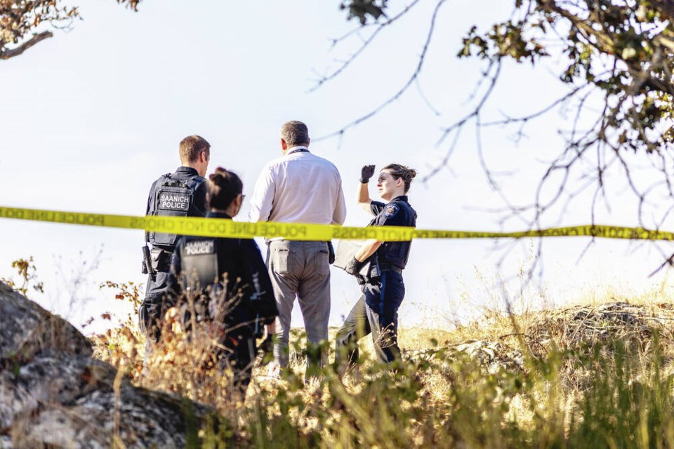Saanich police investigate in the wooded area bordered by Saanich Road, Blanshard Street and the Pat Bay Highway near Uptown on Wednesday. DARREN STONE, TIMES COLONIST 
