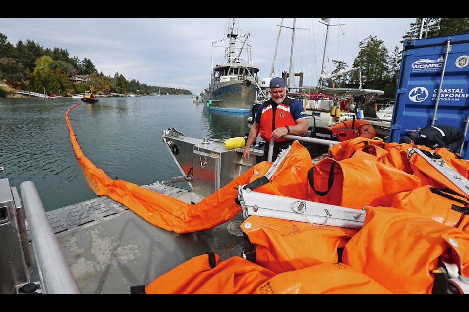 Ian Grantham, training specialist with Western Canada Marine Response Corporation, works on one of the vessels in an oil-spill response exercise at Whaler's Bay on the south side of Galiano Island. ADRIAN LAM, TIMES COLONIST 