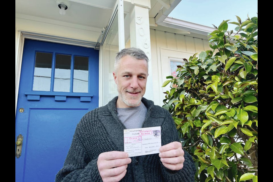 Matthew Rose holds a replica postcard sent by Ernest Albert Underwood to Emily Underwood in ­September 1943. The postcard was delivered to his home as part of Letters Home, an awareness campaign by the Royal Canadian Legion and the Legion National Foundation. TIMES COLONIST 