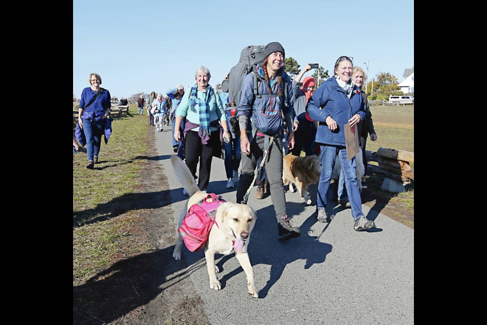 Hiker and solo adventurer Melanie Vogel, with her dog Malo, arrives at Clover Point in Victoria on Saturday, completing her epic five-year hike from coast to coast to coast in Canada. ADRIAN LAM, TIMES COLONIST 