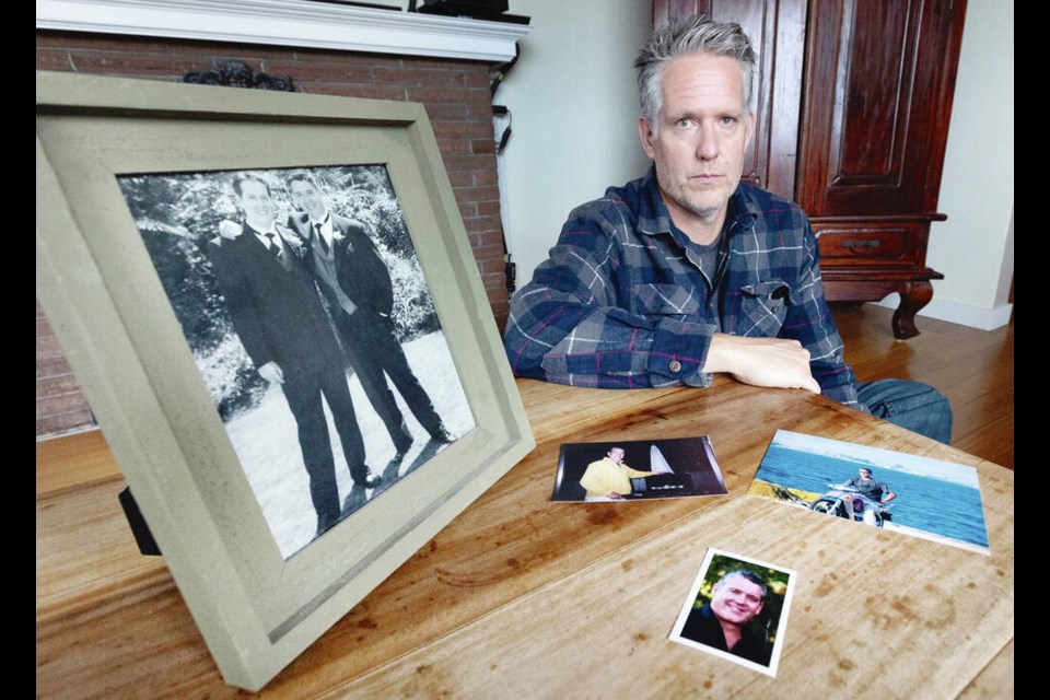 Peter Murray with photos of his brother Barry Murray, who was the best man at his wedding in 1998 (in the photo at left). Barry Murray died of a toxic drug overdose Aug. 3. DARREN STONE, TIMES COLONIST 