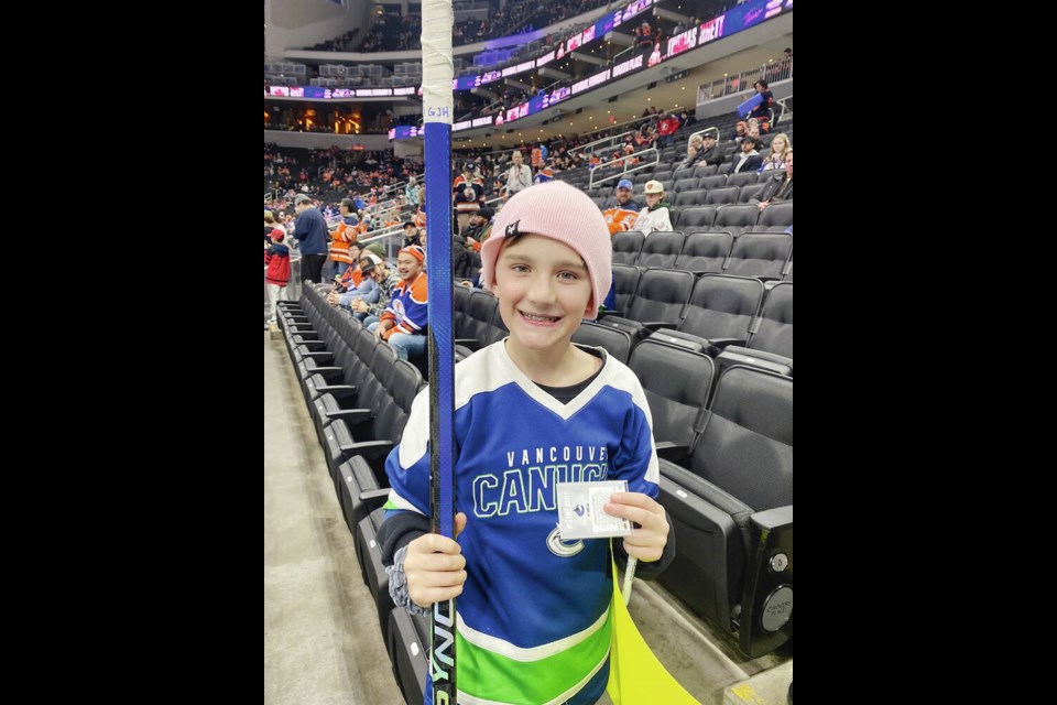 Linden Erwin, of Nanaimo, with a hockey stick given to him by Vancouver Canucks captain Bo Horvat. The stick subsequently went missing on an airline flight. COURTESY JANELLE ERWIN 