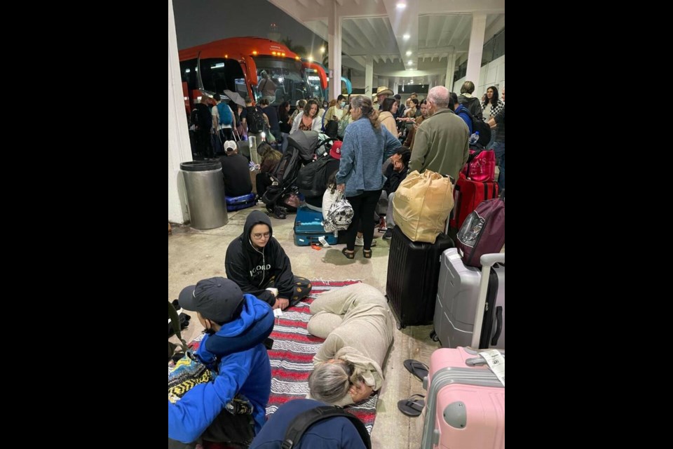 Passengers are seen in a handout photo as they await transport at the airport in Cancun, Mexico, in the early hours of Dec. 25, 2022, after their delayed flight home to Canada was cancelled once again. HINA ITSASO VIA THE CANADIAN PRESS 