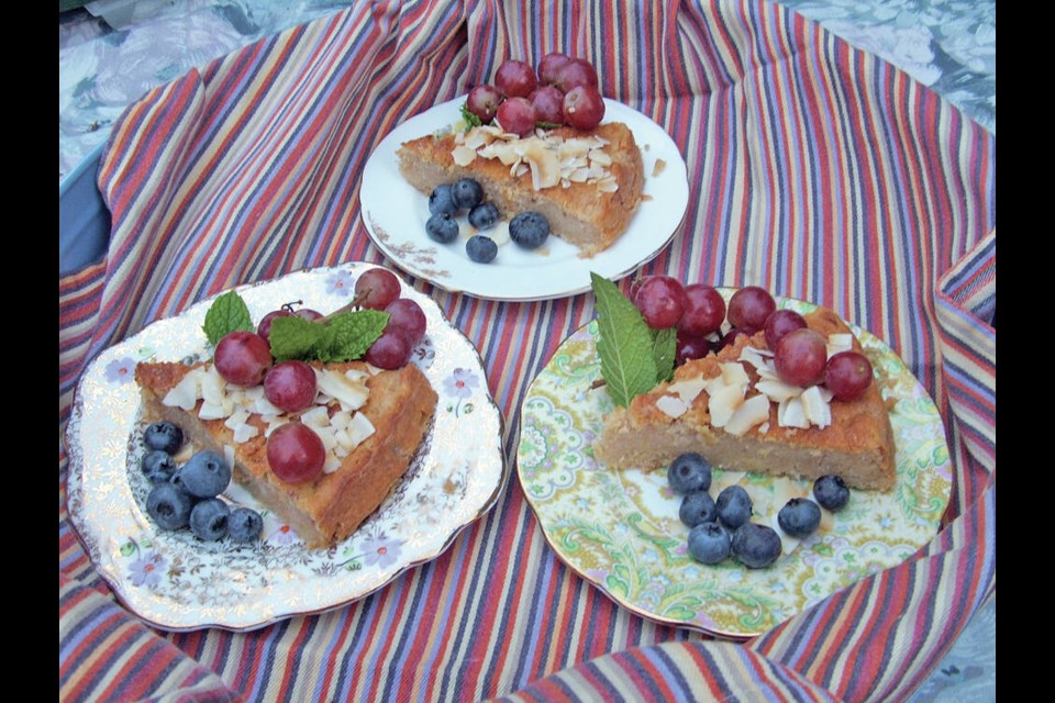 Ricotta cheese is an ingredient in this Italian apple cake, garnished with toasted coconut flakes, grapes, blueberries and mint leaves.	HELEN CHESNUT 