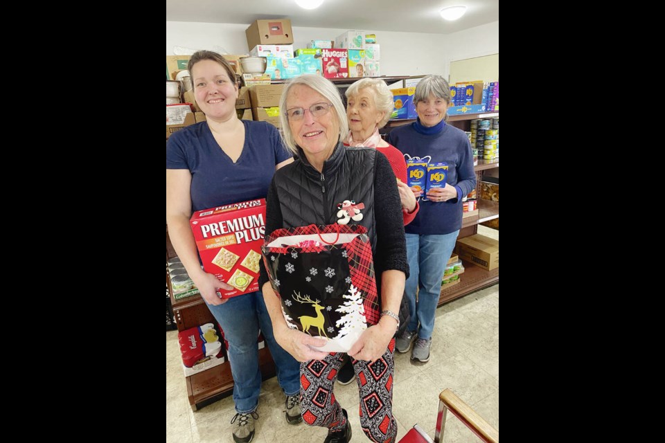 Volunteers, from left, Athena Waite, Cécile Healey, Maggie Watkins and Judi Hirst at the CMS Food Bank. Times Colonist 