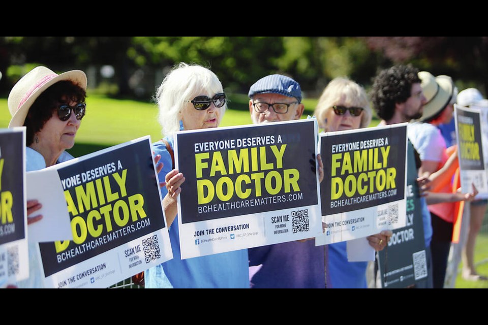 Protesters representing B.C. Health Care Matters rally in front of the Empress Hotel as Canadas premiers met inside the hotel in July. A letter-writer suggests that adding more family physicians in the province could reduce the incidence of extra billing by some MDs. ADRIAN LAM, TIMES COLONIST 