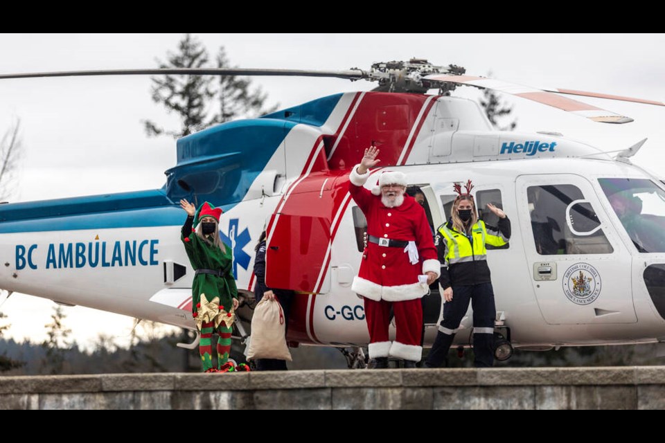 Santa Claus and his entourage arrive at Victoria General Hospital after flying in a B.C. Ambulance Service helicopter. DARREN STONE, TIMES COLONIST 