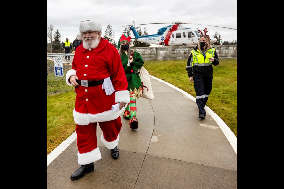 Santa Claus and his entourage arrive at Victoria General Hospital after flying in a B.C. Ambulance Service helicopter. DARREN STONE, TIMES COLONIST 