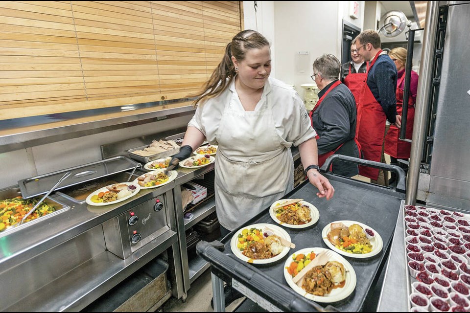 Erica Tiedemann serves lunch at Our Place Society in Victoria on Wednesday. DARREN STONE, TIMES COLONIST 