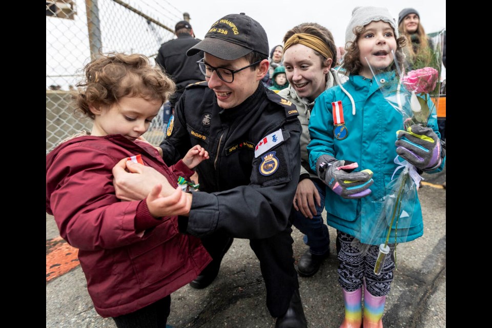 Master sailor Thomas McDavid reunites with wife Colleen McDavid, Penelope McDavid, 2, and Grace McDavid, 5, after 173 days away from home while deployed with HMCS Winnipeg in the Indo-Pacific. DARREN STONE, TIMES COLONIST 