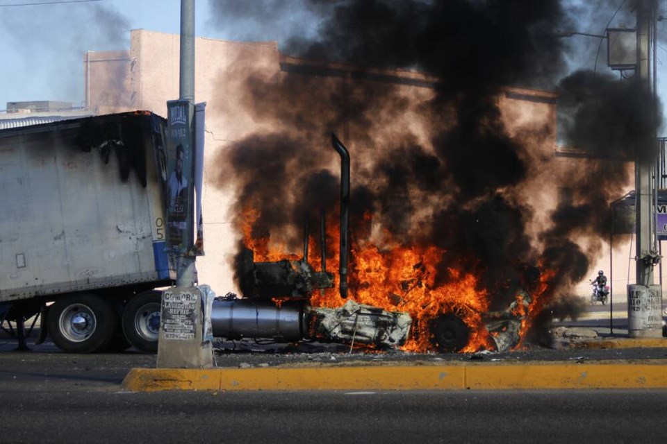 A truck burns on a street in Culiacan, Sinaloa state, on Thursday Jan. 5, 2023. Mexican security forces captured Ovidio Guzmán, an alleged drug trafficker wanted by the United States and one of the sons of former Sinaloa cartel boss Joaquín El Chapo Guzmán, in a pre-dawn operation Thursday that set off gunfights and roadblocks across the western states capital. AP Photo/Martin Urista 