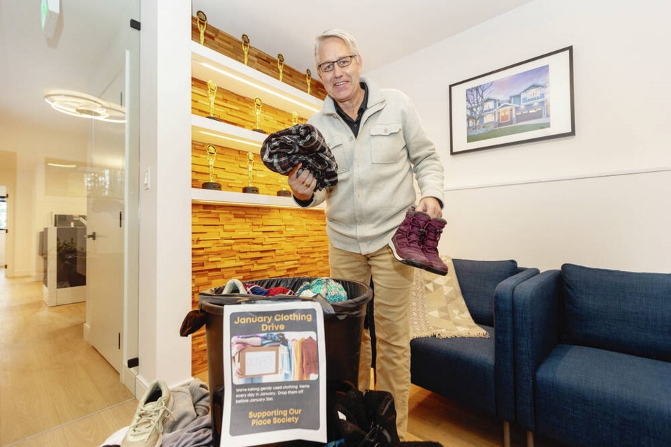 Dave Stephens, president of LIDA Homes, with some of the clothing, shoes, and accessories collected during a clothing drive to benefit local families in need and Our Place Society. Stephens issued a challenge to other local builders to see who can collect the most. DARREN STONE, TIMES COLONIST 