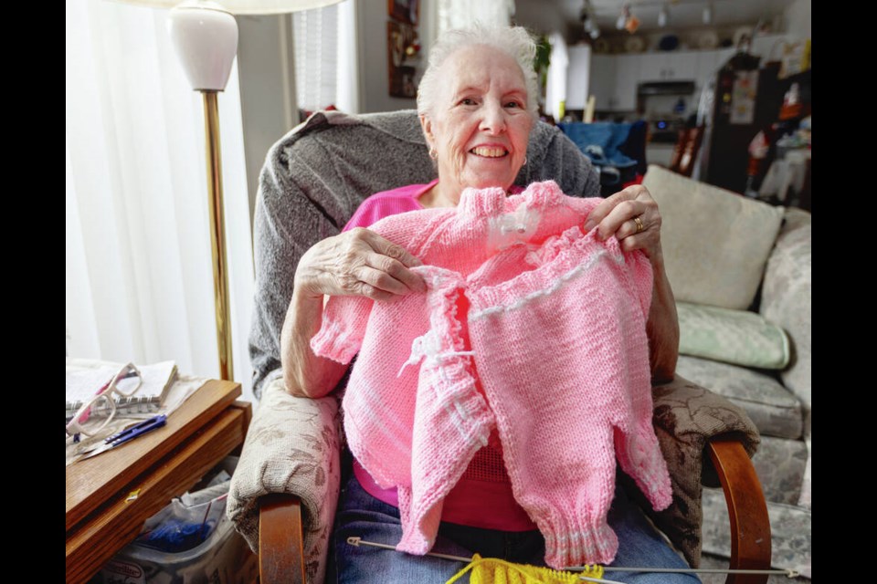 Alice Miles has knitted dozens of childrens garments that will be sent to Europe by Victorias Compassionate Resource Warehouse to clothe Ukrainian refugees. DARREN STONE, TIMES COLONIST 