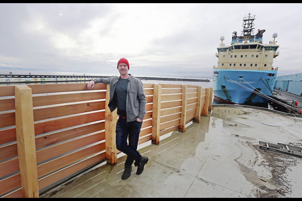 Nick van Buren stands on the barge at Ogden Point where a new floating sauna is being built that will sit at Ship Point. ADRIAN LAM, TIMES COLONIST 