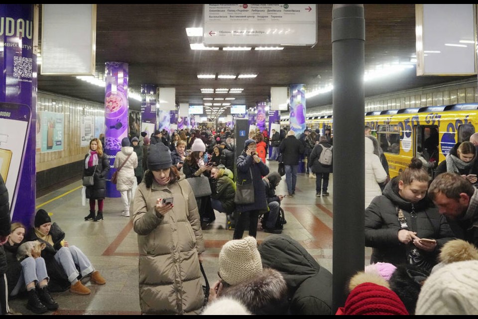 People rest in a subway station, being used as a bomb shelter during a rocket attack in Kyiv, Ukraine, Friday, Dec. 16, 2022. (AP Photo/Efrem Lukatsky) 