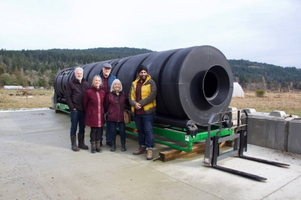 From left, CRD director Gary Holman, Island Farm Trust chair Sheila Dobie, project manager Kevin Chipperfield, organic grower Anne Macey and Aman Singh, parliamentary secretary for the environment, with the compost drum being set up on Salt Spring Island. CAPITAL REGIONAL DISTRICT 