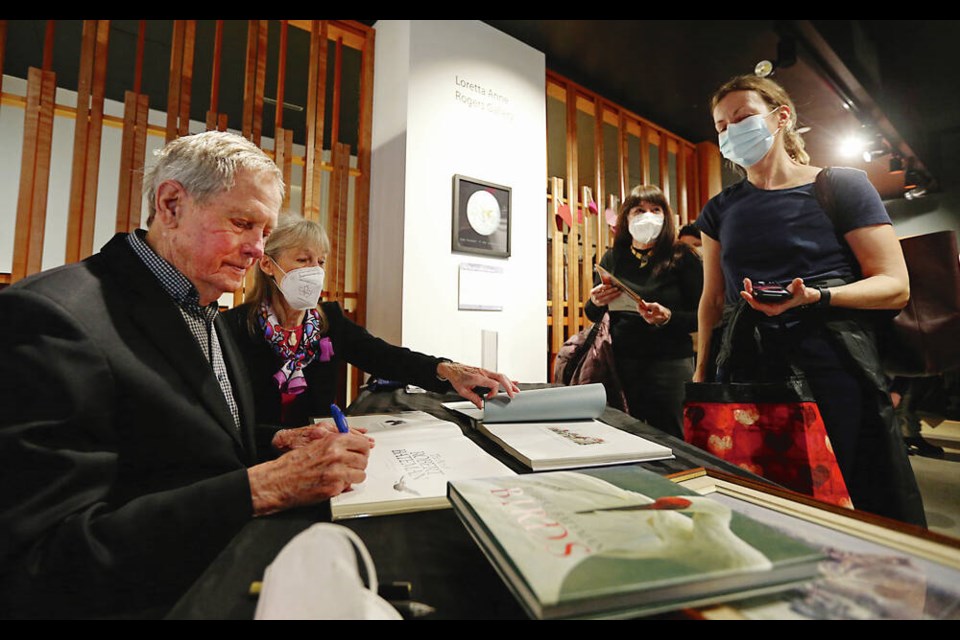 Celebrated artist and naturalist Robert Bateman, with his wife Birgit Freybe, signs books and artwork for Barb Cottingham at The Bateman Gallery on Saturday, the final day of its operation after 10 years at the CPR Steamship Terminal. A long line of people waited for a chance to meet the Batemans.  ADRIAN LAM, TIMES COLONIST  