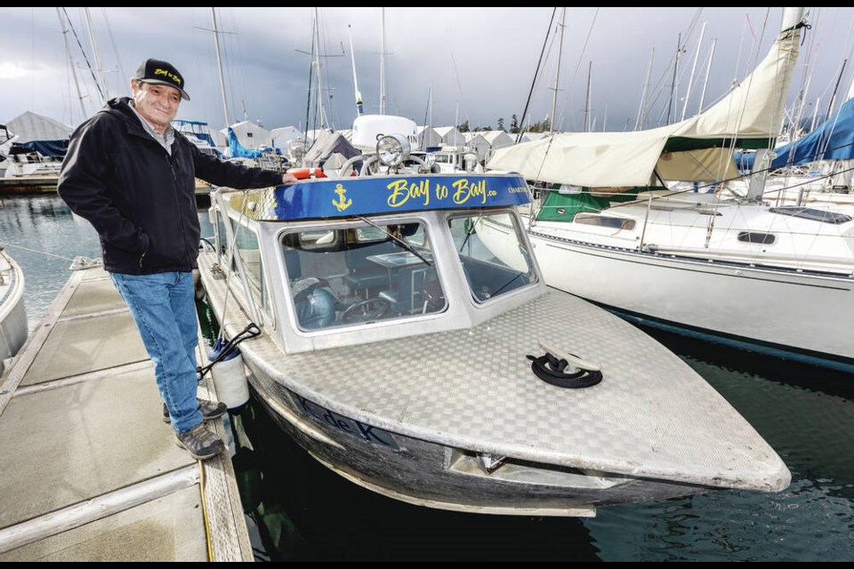 Bay-to-Bay Charters owner Miles Arsenault and his water taxi K de K at Van Isle Marina. DARREN STONE, TIMES COLONIST 