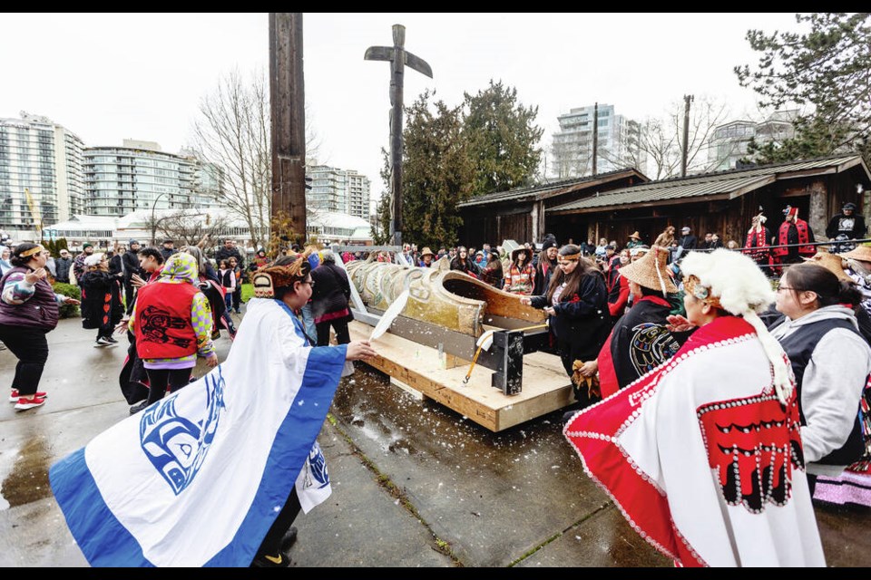 Ceremonies for the repatriation of a Nuxalk Nation totem pole are held next to Mungo Martin House in Thunderbird Park at the Royal B.C. Museum on Monday. The pole was carved in the mid-1800s and will be returning to Nuxalk territory near Bella Coola. DARREN STONE, TIMES COLONIST 