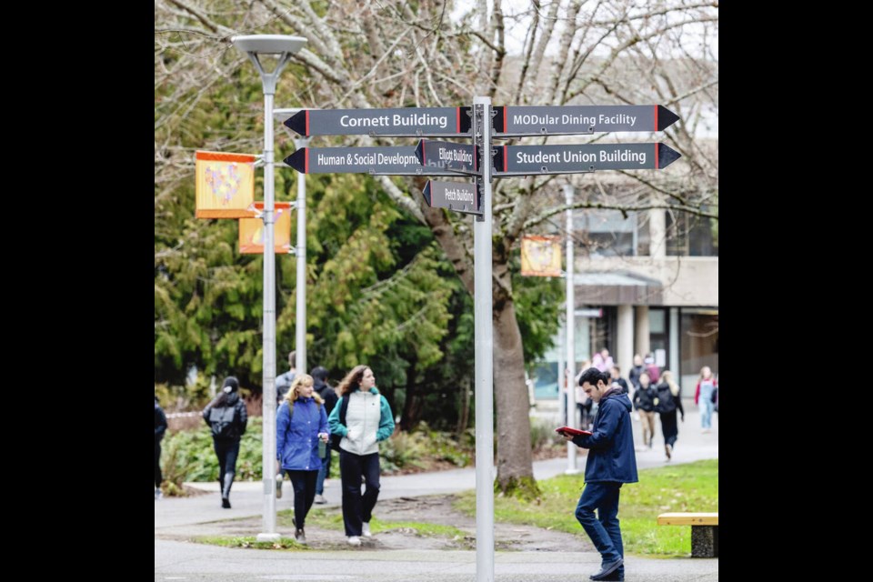 University of Victoria students walk between classes in front of the McPherson Library. 
DARREN STONE, TIMES COLONIST 