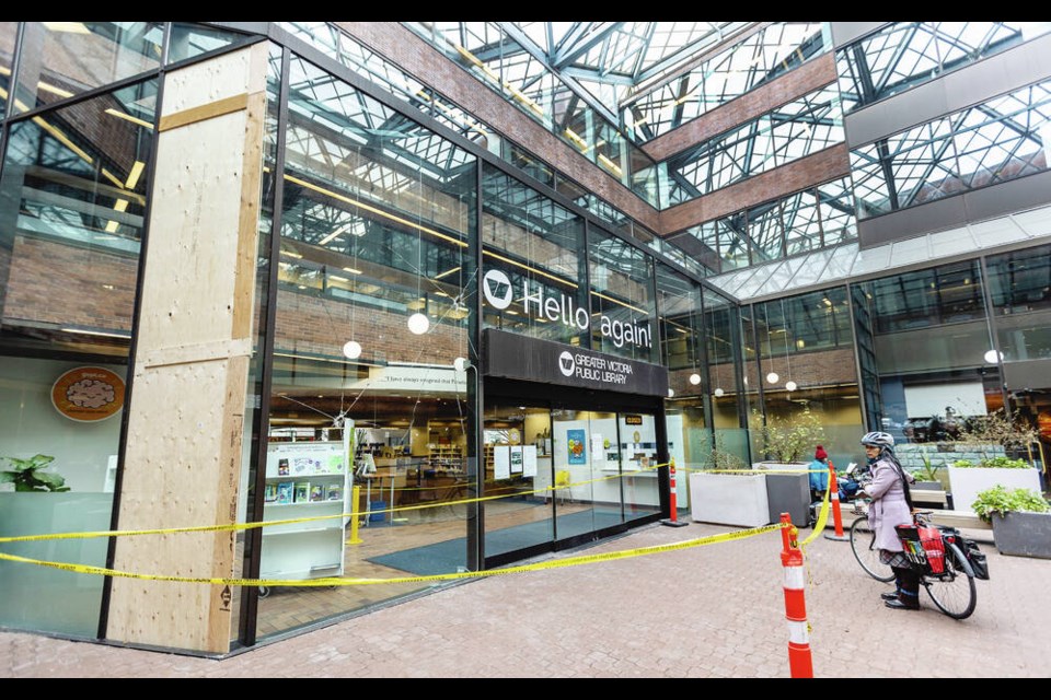 Yellow tape surrounds the entrance to the Greater Victoria Public Library's central branch on Wednesday after the glass doors were broken. DARREN STONE, TIMES COLONIST 