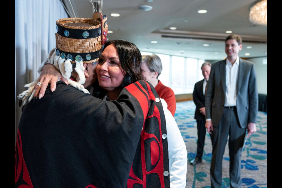 Haisla Nation Chief Councillor Crystal Smith embraces Hereditary Chief of the Haisla NationJake Duncan as Premier David Eby looks on after a press conference announcing that the Cedar LNG project has been given environmental approval, in Vancouver, Tuesday March 14, 2023. THE CANADIAN PRESS/Rich Lam