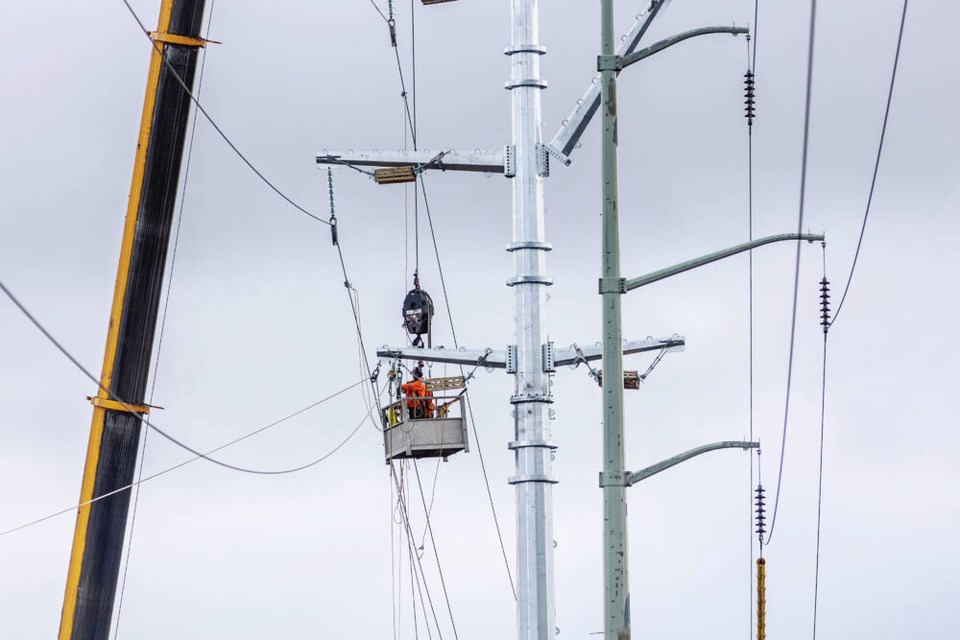 B.C. Hydro crews work on a replacement tower near the roundabout on Langford Parkway south of Leigh Road. DARREN STONE, TIMES COLONIST 