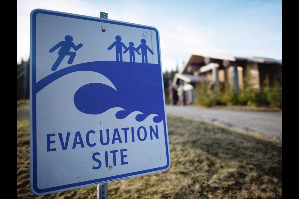 A tsunami evacuation site sign is shown on high ground near the House of Huuayaht in the Village of Anacla in Pachena Bay. JONATHAN HAYWARD, THE CANADIAN PRESS  