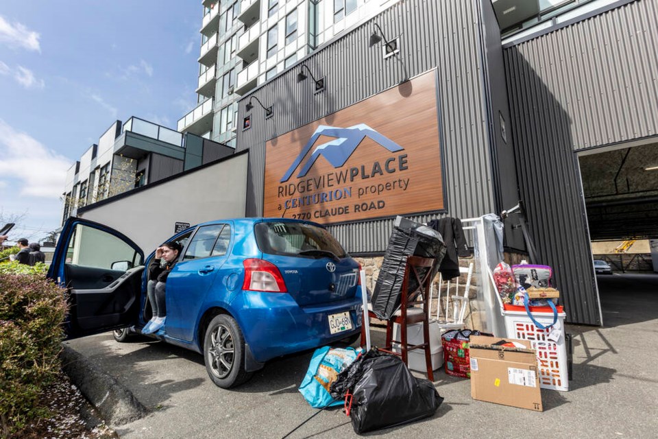 Resident Nicole Tremblay with belongings outside Ridgeview Place, 2770 Claude Rd. in Langford. The building has been evacuated after concerns were raised about the safety of the structure. DARREN STONE, TIMES COLONIST 