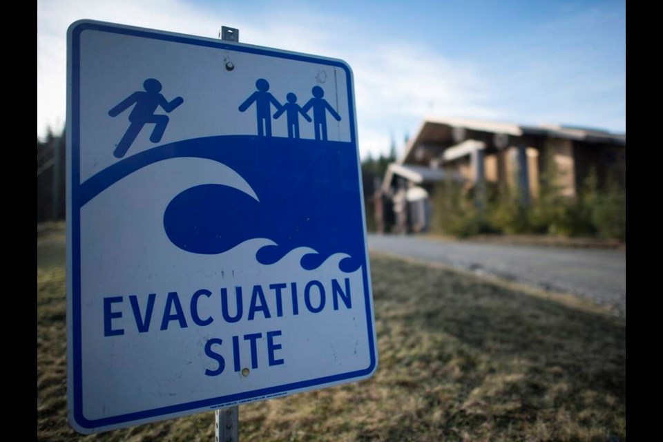 A tsunami evacuation site sign is shown on high ground near the House of Huuayaht in the Village of Anacla in Pachena Bay, B.C. JONATHAN HAYWARD, THE CANADIAN PRESS