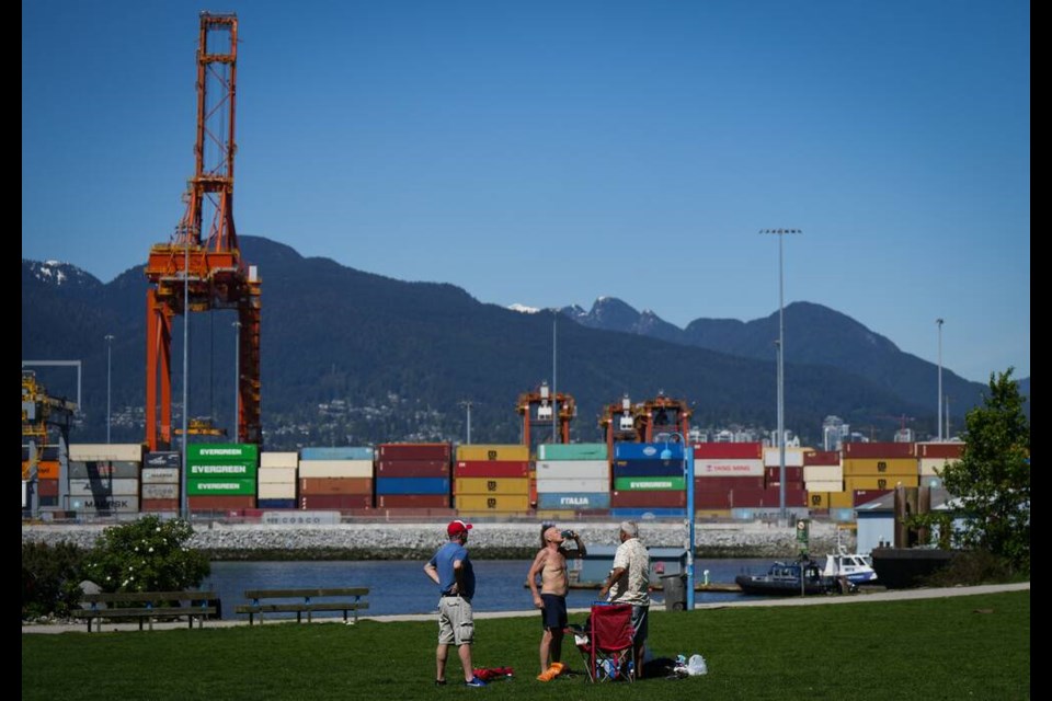 A man drinks a beer at Crab Park in Vancouver, on Saturday, May 13, 2023.Flood and fire risks in B.C.'s interior continue as unseasonably hot weather gripped much of the province this weekend, as some hard-hit communities grapple with potential evacuations and clean-up efforts from earlier weather events.THE CANADIAN PRESS/Darryl Dyck