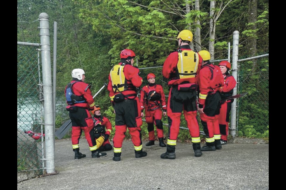 Comox Valley Search and Rescue crews get ready to enter the Puntledge River to reach a family who became stranded after trying to float down it. COMOX VALLEY SEARCH AND RESCUE