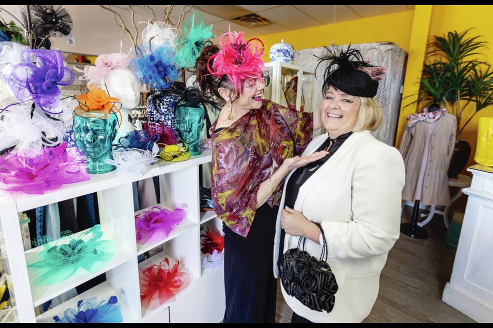 House of Lily Koi owner Shai Thompson, left, and sales rep Karen Takacs with the store's stock of fascinators, a headpiece often worn in the U.K. for high-society events. DARREN STONE, TIMES COLONIST 