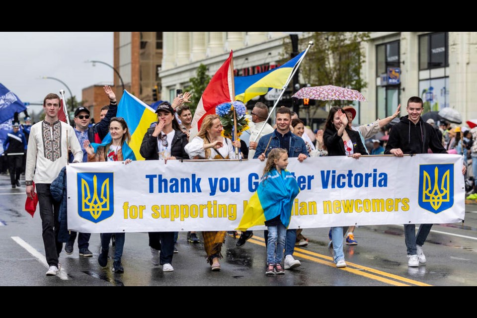 Ukrainian newcomers with a thank-you banner at the Victoria Day Parade. DARREN STONE, TIMES COLONIST 