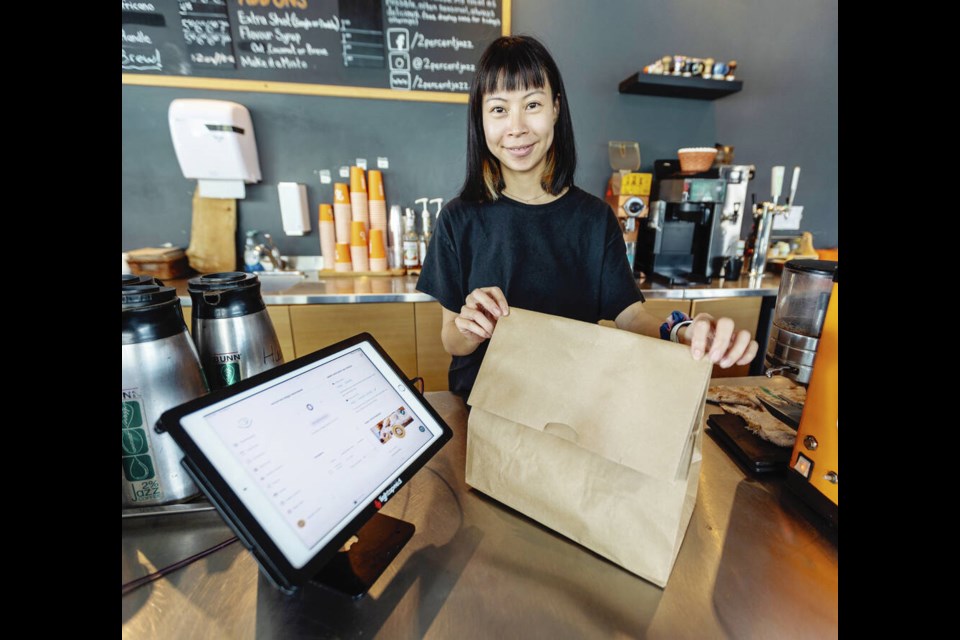 2% Jazz barista Ting Yang with the Too Good To Go app and a bag of surplus food sold at a discount at the end of the day. DARREN STONE, TIMES COLONIST 