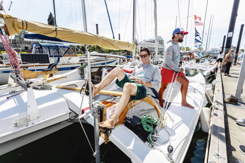 Race to Alaska participant Gabe Mills, with John Totten, demonstrates the pedalling station on the Dogsmile Adventures boat Mahana at the Victoria Causeway Marina. The two are from of Coeur dAlene, Idaho. DARREN STONE, TIMES COLONIST 