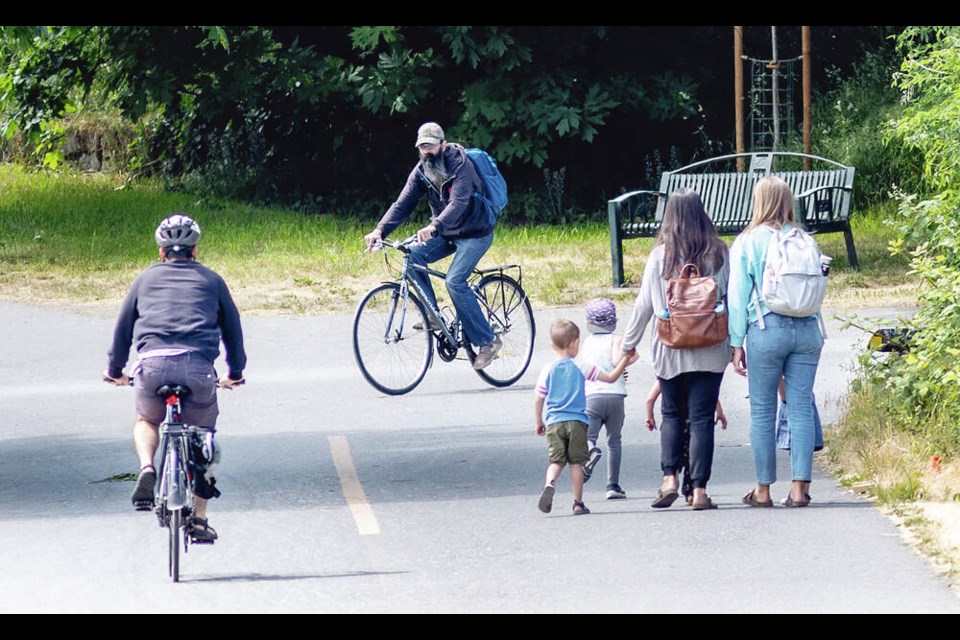 Cyclists and pedestrians share the Galloping Goose Regional Trail just west of the Selkirk Trestle. DARREN STONE, TIMES COLONIST 