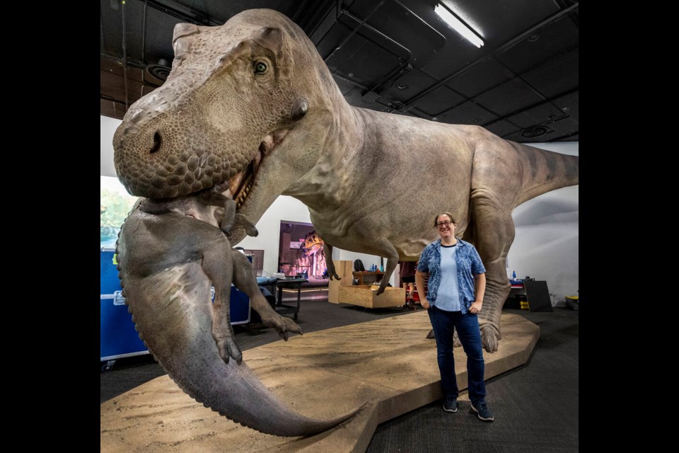 Victoria Arbour, head paleontologist at the Royal B.C. Museum, in front of a life-sized model of Tyrannosaurus rex SUE devouring a juvenile Edmontosaurus at the SUE: The T. rex Experience exhibit. DARREN STONE, TIMES COLONIST 