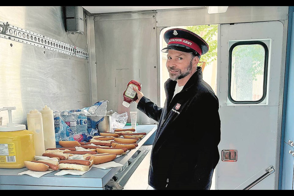 Salvation Army Major Michael Ramsay in Port Alberni prepares a meal in the food bank truck on Tuesday. SUBMITTED 