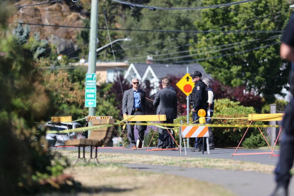 Detectives at the scene of a body’s discovery off Beach Drive on Wednesday, July 26. DARREN STONE, TIMES COLONIST 