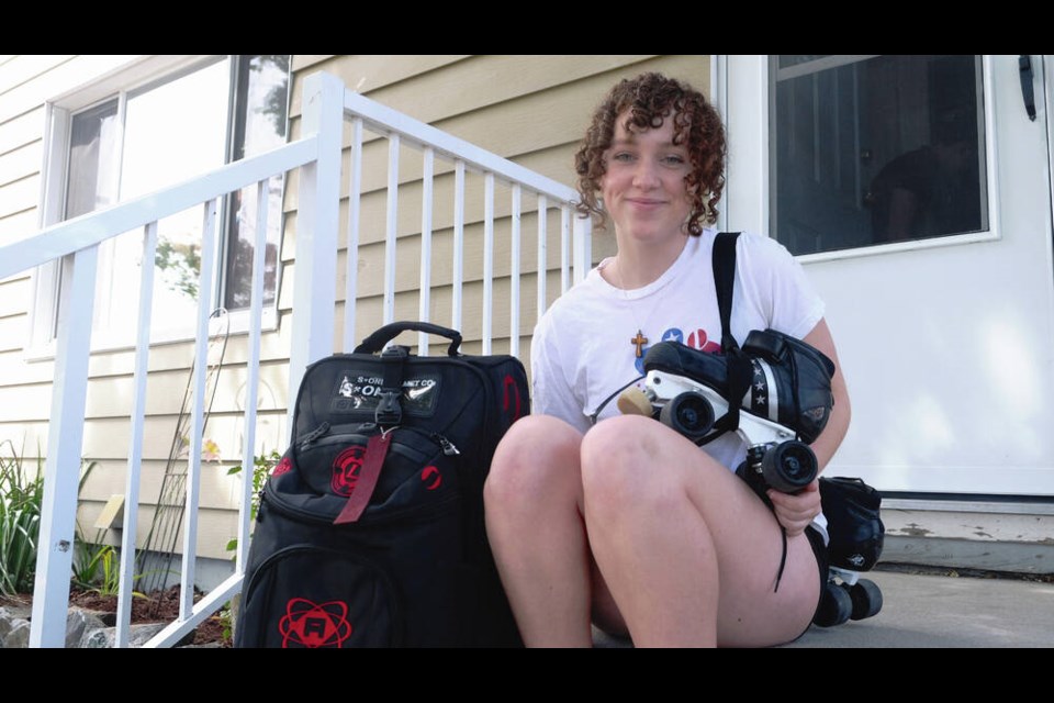 Naomi Morrell takes a break from packing to pose with her skates in front of her Belmont Park home. TIMES COLONIST 