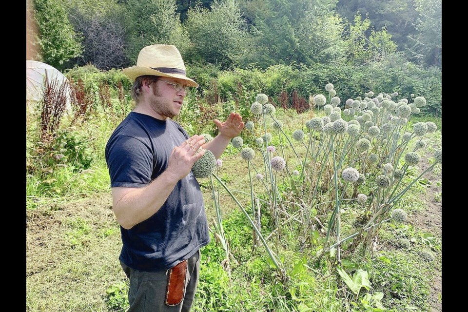 Adam Schick explains the benefits of ecological ­agriculture methods and locally adapted seeds, at ­Linnaea Farm. Seeds are collected from plants that have evolved over time to thrive in local conditions and that will continue to adapt to local climate changes.  ROCHELLE BAKER, CANADA’S NATIONAL OBSERVER 