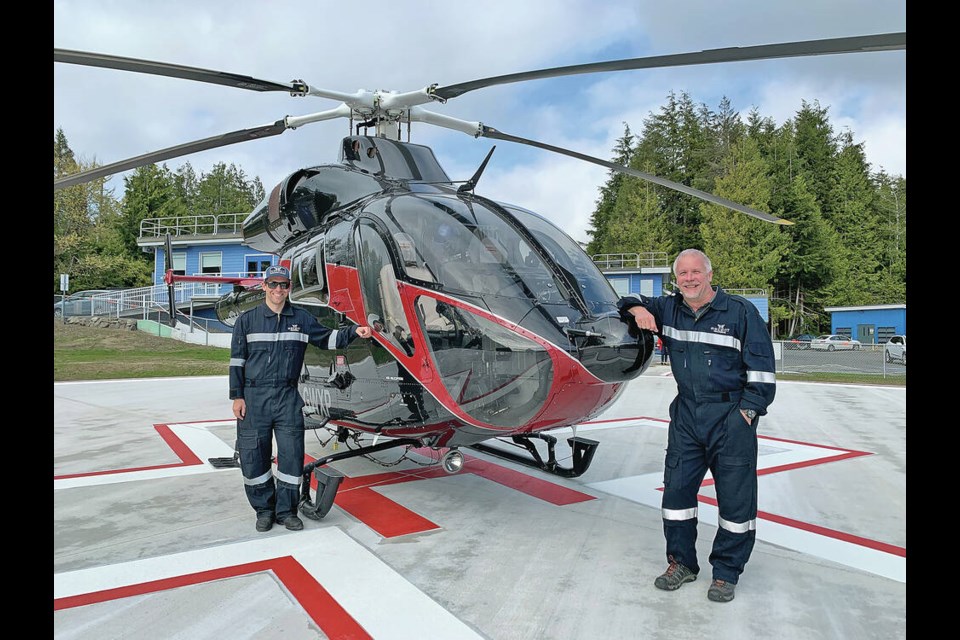 An Ascent air ambulance helicopter at the Tofino helipad, with company co-owner Trent Lemke, right, and chief pilot Chad Freisen. ASCENT HELICOPTERS 