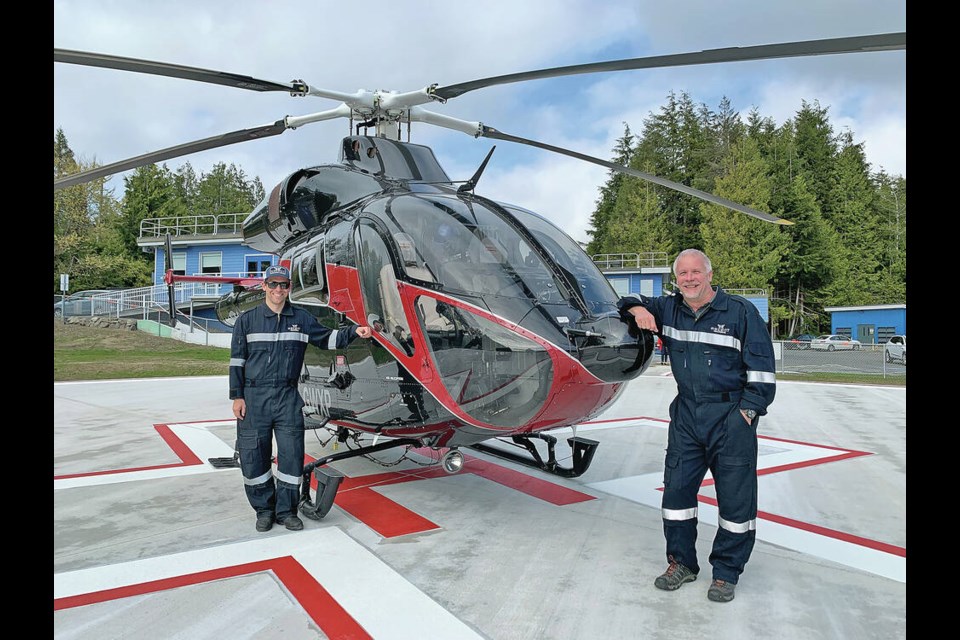 An Ascent air ambulance helicopter at the Tofino helipad, with company co-owner Trent Lemke, right, and chief pilot Chad Freisen. ASCENT HELICOPTERS 