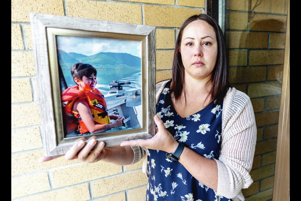 Tanisha Bonsdorf holds a picture of her son Carter Logan McMenamie Bonsdorf, who died on Aug. 24, 2019 at the age of nine. DARREN STONE, TIMES COLONIST 