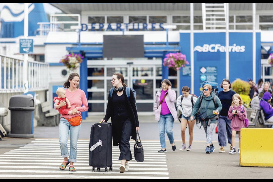 Foot passengers leave B.C. Ferries’ Swartz Bay terminal on Monday. DARREN STONE, TIMES COLONIST 